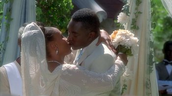 Movie still from “The Brothers” (2001), directed by Gary Hardwick – A man and woman kissing in front of a white curtain; Close Up shot, High angle