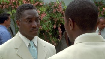 Movie still from “The Brothers” (2001), directed by Gary Hardwick – A man in a white suit and a man in a blue tie; Close Up shot, Over the shoulder angle