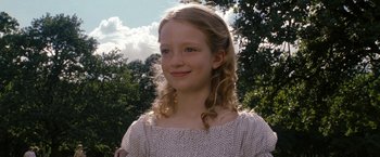 Movie still from “The Brothers Bloom” (2008), directed by Rian Johnson – A young girl with long blonde curly hair; Close Up shot, Low angle