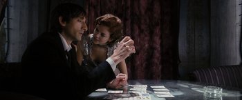 Movie still from “The Brothers Bloom” (2008), directed by Rian Johnson – A man and a woman are playing a card game together; Medium shot, Over the shoulder angle