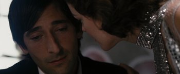 Movie still from “The Brothers Bloom” (2008), directed by Rian Johnson – A person touching a mans face; Close Up shot, Over the shoulder angle