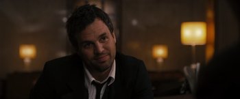 Movie still from “The Brothers Bloom” (2008), directed by Rian Johnson – A person wearing a suit and tie; Close Up shot, Over the shoulder angle