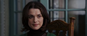 Movie still from “The Brothers Bloom” (2008), directed by Rian Johnson – A person sitting in a chair; Close Up shot, Over the shoulder angle