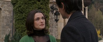 Movie still from “The Brothers Bloom” (2008), directed by Rian Johnson – A man and a woman standing next to each other outside; Close Up shot, Over the shoulder angle