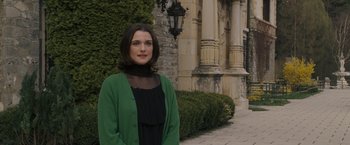 Movie still from “The Brothers Bloom” (2008), directed by Rian Johnson – A woman standing in front of an old building; Medium shot, Over the shoulder angle