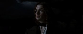 Movie still from “The Brothers Bloom” (2008), directed by Rian Johnson – A woman with long hair wearing a black jacket; Close Up shot, Low angle