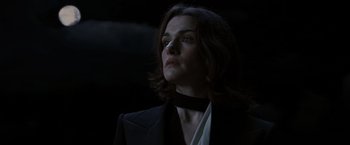 Movie still from “The Brothers Bloom” (2008), directed by Rian Johnson – A woman in a black jacket and a white collar; Close Up shot, Low angle