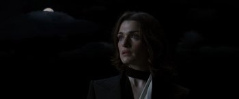 Movie still from “The Brothers Bloom” (2008), directed by Rian Johnson – A woman in a black jacket and a white shirt; Close Up shot, Low angle