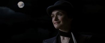 Movie still from “The Brothers Bloom” (2008), directed by Rian Johnson – A woman wearing a hat and a black suit; Close Up shot, Low angle