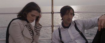 Movie still from “The Brothers Bloom” (2008), directed by Rian Johnson – A man and a woman sitting next to each other on a boat; Close Up shot, High angle