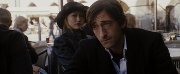 Movie still from “The Brothers Bloom” (2008), directed by Rian Johnson – A man and a woman are sitting in a chair; Close Up shot, Over the shoulder angle