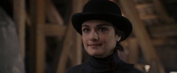 Movie still from “The Brothers Bloom” (2008), directed by Rian Johnson – A person wearing a hat; Close Up shot, Over the shoulder angle