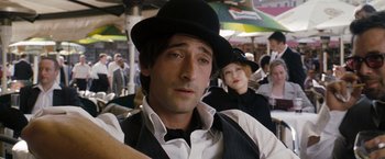 Movie still from “The Brothers Bloom” (2008), directed by Rian Johnson – A man wearing a black hat and a woman in a black hat; Close Up shot, Over the shoulder angle