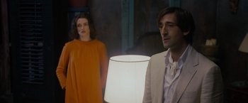 Movie still from “The Brothers Bloom” (2008), directed by Rian Johnson – A man and a woman standing in front of a lamp; Medium shot, Over the shoulder angle