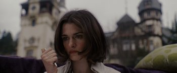 Movie still from “The Brothers Bloom” (2008), directed by Rian Johnson – A person holding a cigarette in her mouth; Close Up shot, High angle