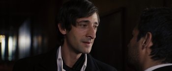 Movie still from “The Brothers Bloom” (2008), directed by Rian Johnson – A person wearing a suit and tie; Close Up shot, High angle