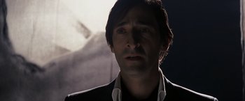 Movie still from “The Brothers Bloom” (2008), directed by Rian Johnson – A person wearing a suit and tie; Close Up shot, Low angle