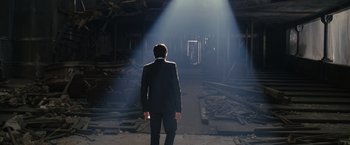 Movie still from “The Brothers Bloom” (2008), directed by Rian Johnson – A man in a suit standing in the middle of an empty room; Wide shot, Low angle