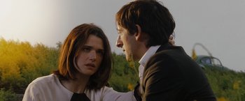 Movie still from “The Brothers Bloom” (2008), directed by Rian Johnson – A man and a woman standing next to each other; Close Up shot, Over the shoulder angle