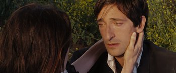 Movie still from “The Brothers Bloom” (2008), directed by Rian Johnson – A person wearing a suit and tie; Close Up shot, High angle