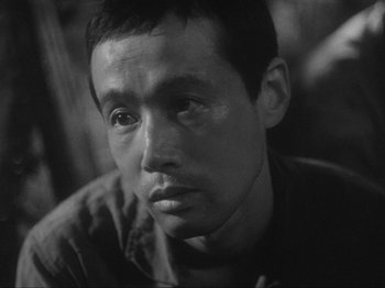 Black and white photograph of a man with a sad look on his face