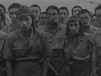 A group of men standing next to each other in military uniforms