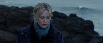 Movie still from “The Burning Plain” (2008), directed by Guillermo Arriaga – A woman in a blue jacket and a blue scarf; Close Up shot, Over the shoulder angle