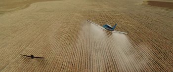 Movie still from “The Burning Plain” (2008), directed by Guillermo Arriaga – An airplane is flying over a field of grain; Extreme Wide shot, Overhead angle