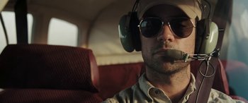 Movie still from “The Burning Plain” (2008), directed by Guillermo Arriaga – A person wearing headphones and sunglasses; Close Up shot, Low angle