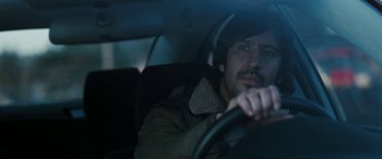 Movie still from “The Burning Plain” (2008), directed by Guillermo Arriaga – A man sitting in the driver's seat of a car; Close Up shot, Over the shoulder angle