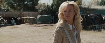 Movie still from “The Burning Plain” (2008), directed by Guillermo Arriaga – A woman with blonde hair wearing a beige sweater; Close Up shot, Over the shoulder angle