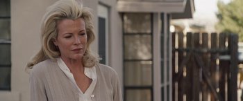 Movie still from “The Burning Plain” (2008), directed by Guillermo Arriaga – A woman with blonde hair is standing in a room; Close Up shot, Over the shoulder angle