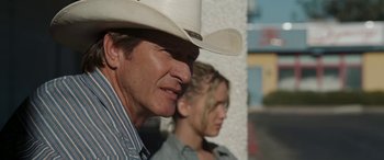 Movie still from “The Burning Plain” (2008), directed by Guillermo Arriaga – A man wearing a cowboy hat next to a woman; Close Up shot, Over the shoulder angle