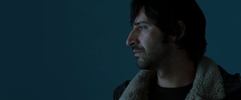 Movie still from “The Burning Plain” (2008), directed by Guillermo Arriaga – A person wearing a jacket; Close Up shot, Low angle