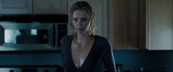 Movie still from “The Burning Plain” (2008), directed by Guillermo Arriaga – A woman with wet hair standing in a kitchen; Close Up shot, Low angle