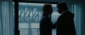 Movie still from “The Burning Plain” (2008), directed by Guillermo Arriaga – Two people standing next to each other in front of a window; Medium shot, Over the shoulder angle