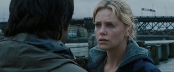 Movie still from “The Burning Plain” (2008), directed by Guillermo Arriaga – Two people standing next to each other near a body of water; Close Up shot, Over the shoulder angle