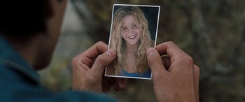 Movie still from “The Burning Plain” (2008), directed by Guillermo Arriaga – A person holding up a picture of a woman; Close Up shot, Over the shoulder angle