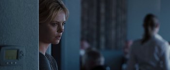 Movie still from “The Burning Plain” (2008), directed by Guillermo Arriaga – Charlize theron in a room; Close Up shot, Over the shoulder angle