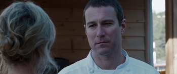 Movie still from “The Burning Plain” (2008), directed by Guillermo Arriaga – A person wearing a chef's outfit; Close Up shot, Over the shoulder angle