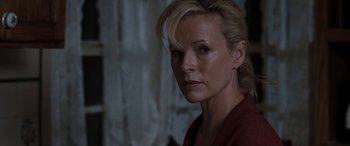 Movie still from “The Burning Plain” (2008), directed by Guillermo Arriaga – A person with blonde hair; Close Up shot, Over the shoulder angle