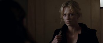 Movie still from “The Burning Plain” (2008), directed by Guillermo Arriaga – A woman holding a knife in a dark room; Close Up shot, Over the shoulder angle