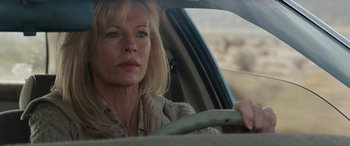 Movie still from “The Burning Plain” (2008), directed by Guillermo Arriaga – A woman sitting in the drivers seat of a car; Close Up shot, Low angle