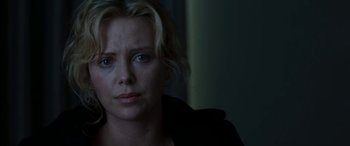 Movie still from “The Burning Plain” (2008), directed by Guillermo Arriaga – A person wearing a black jacket; Close Up shot, Over the shoulder angle