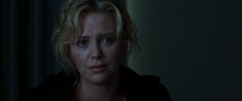 Movie still from “The Burning Plain” (2008), directed by Guillermo Arriaga – A person with a sad look on their face; Close Up shot, Over the shoulder angle