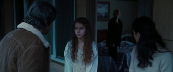 Movie still from “The Burning Plain” (2008), directed by Guillermo Arriaga – A young girl standing next to a woman in front of a window; Medium shot, Over the shoulder angle
