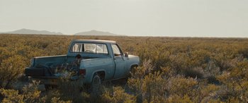 Movie still from “The Burning Plain” (2008), directed by Guillermo Arriaga – An old pick - up truck parked in the middle of a field; Extreme Wide shot, Low angle