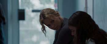 Movie still from “The Burning Plain” (2008), directed by Guillermo Arriaga – A woman sitting next to another woman in a room; Close Up shot, Over the shoulder angle