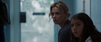 Movie still from “The Burning Plain” (2008), directed by Guillermo Arriaga – Charlize theron looking at the camera; Close Up shot, Over the shoulder angle