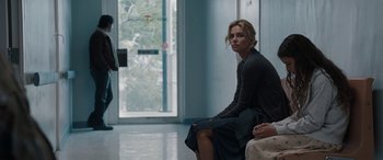 Movie still from “The Burning Plain” (2008), directed by Guillermo Arriaga – A woman sitting on a chair in a room; Wide shot, Low angle